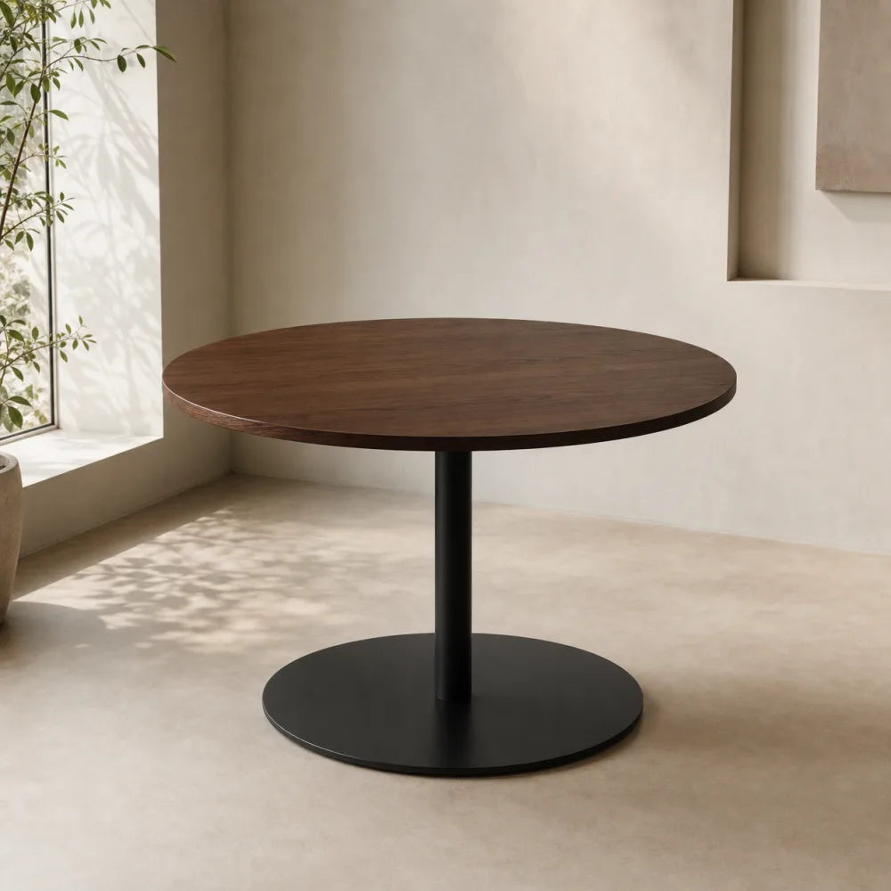 Editorial concept image of a round walnut dining table